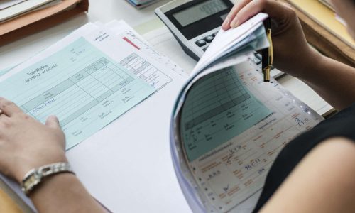 Adult asian woman working on payment bills accounting summary data